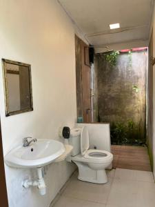 a bathroom with a toilet and a sink at Sailor's Rest in Kampung Janda Baik