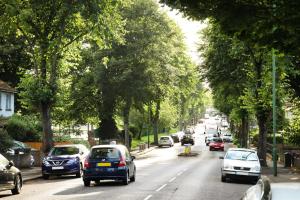 a busy street with cars driving down a street with trees at Convenient 1-Bed Apartment - Ideal for Working Away, Free Parking, Pet Friendly, Netflix in Sheffield