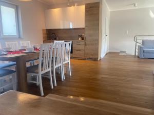 a kitchen and dining room with a table and chairs at Apartament Daleszyce in Daleszyce