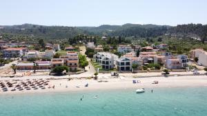 an aerial view of a beach with people in the water at Villa Oleandra by the sea in Polykhrono