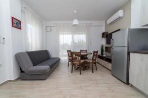 a kitchen and dining room with a couch and a table at Danai Maisonettes Ofriniou in Ofrínion