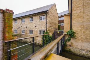 a brick building with a wooden bridge in front of it at Central but quiet in Oxford