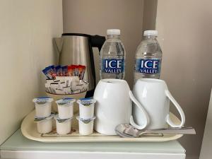 a shelf with two bottles of ice water and cups at The Sandrock in Clacton-on-Sea