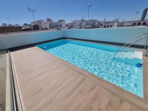 a swimming pool on the roof of a building at Luxury apartment in sevilla center in Seville