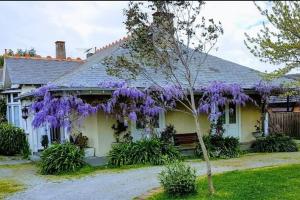 a house with purple wisteria on the side of it at Outstanding property Close to Melb Airport in Melbourne