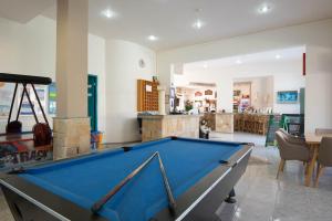 a pool table in the middle of a room at Barbie Hotel Apartments in Ialyssos