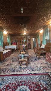 a living room with couches and a rug at Houseboat Pride of India in Srinagar