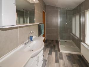 a bathroom with a sink and a shower and a tub at Tilly's Lodge in Doncaster +18 photos