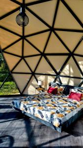 a bedroom with a large bed in a tent at Glamping dome tent BUUDA in Salacgrīva