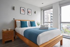 a bedroom with a large bed and a window at Wembley Stadium by Viridian Apartments in London