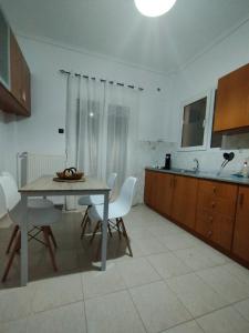 a kitchen with a table and chairs in a room at Mirina center apartments in Myrina +45 photos