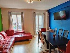 a living room with a couch and a table at Downtown Family&Friends in Interlaken