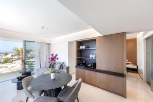 a living room with a table and chairs at Pavlo Napa Beach Hotel in Ayia Napa