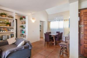 a living room and dining room with a table and chairs at Bahia Dorada 4 in Estepona
