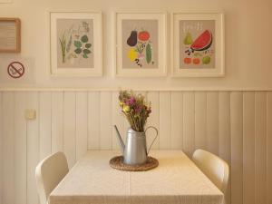 a table with a vase with flowers on it at "COZY LOFT", TERRACE, PARKING and SWIMMING POOL in Málaga