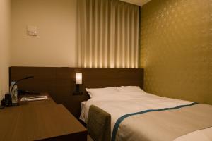Postel nebo postele na pokoji v ubytování Tosei Hotel Cocone Ueno
