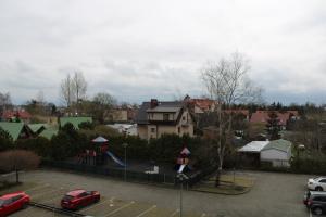 a playground in a parking lot with cars parked at Apartament BARTUŚ do 4 osób - STEGNA mierzeja wiślana in Stegna