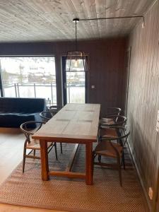 a wooden table and chairs in a room at Fjellnest Hemsedal in Hemsedal