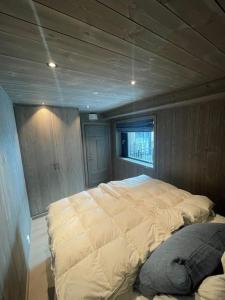 a bedroom with a large bed in a house at Fjellnest Hemsedal in Hemsedal
