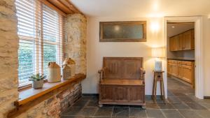 a kitchen with a wooden counter and a window at Wynyard Mill in Malmesbury