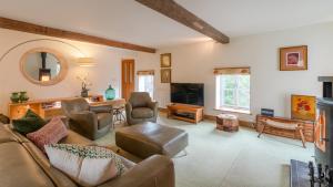a living room with a couch and a table at Wynyard Mill in Malmesbury