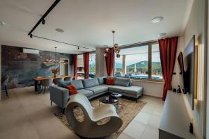 a living room with a couch and a table at Villa Vitrenik, Cista Velika, Makarska-Imotski in Velika Cista