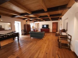 a large living room with wooden floors and a piano at Corte Signoretti - Hystorical Villa in Canale Monterano