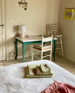 a bedroom with a table and a bed with a tray at Chambres d'Hôtes Lefoulon in Pirou