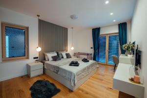 a bedroom with a large bed with blue curtains at Villa Vitrenik, Cista Velika, Makarska-Imotski in Velika Cista +32 photos