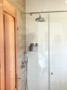 a shower with a glass door in a bathroom at Quinta Amarela - B&B in Nazaré