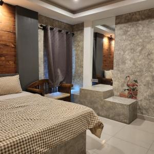 een slaapkamer met een bed en een badkamer met een bad bij Loft House Resort Pattaya in Jomtien Beach