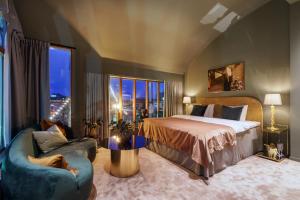 a bedroom with a bed and a couch and a window at Berns, Historical Boutique Hotel & House of Entertainment since 1863 in Stockholm +23 photos