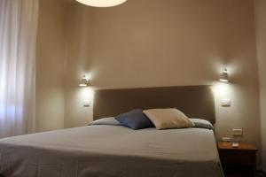 a bedroom with a bed with two pillows on it at Hotel Ristorante Il Gabbiano in Cecina