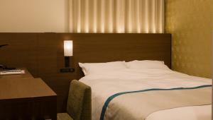 Postel nebo postele na pokoji v ubytování Tosei Hotel Cocone Ueno