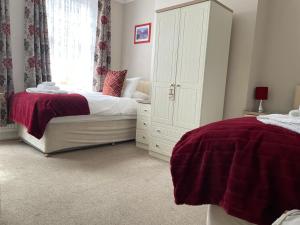 a bedroom with two beds and a large window at The Sandrock in Clacton-on-Sea