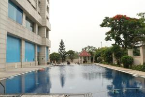 a swimming pool in front of a building at Holiday Inn Chandigarh Panchkula, an IHG Hotel in Chandīgarh