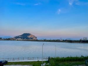 a large body of water with a mountain in the background at Locazione Turistica Misano in Monte di Procida +5 photos