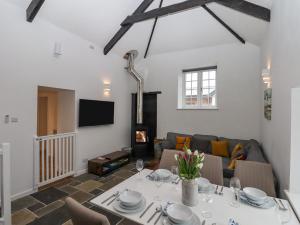 a living room with a table and a couch at Strawberry Bank - Pipistrelle in Holsworthy