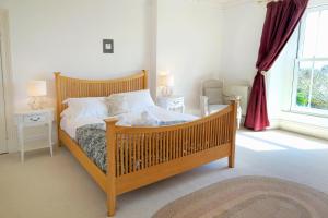a bedroom with a wooden bed with a stuffed animal on it at The Retreat - 5 Bedroom House - Horton in Horton
