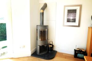 a wood stove in a corner of a room at The Retreat - 5 Bedroom House - Horton in Horton