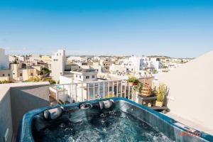 a hot tub on the roof of a building at Modern Apartments in Malta's charming Mosta in Mosta