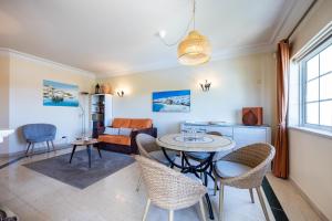 a living room with a table and chairs at Apartment Presa de Moura in Carvoeiro