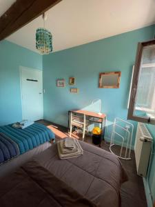 sypialnia z 2 łóżkami i biurkiem w obiekcie Chambres d'Hôtes Lefoulon w mieście Pirou