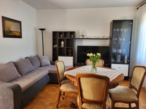 a living room with a couch and a table at Apartments Gorana in Novi Vinodolski