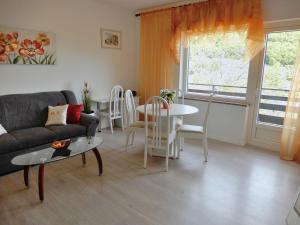 a living room with a couch and a table at Apartment Ketty in Mošćenička Draga