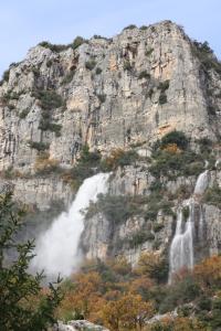 a waterfall on the side of a mountain at Chambre d'hôtes insolite Dreams Bubble in Gourdon
