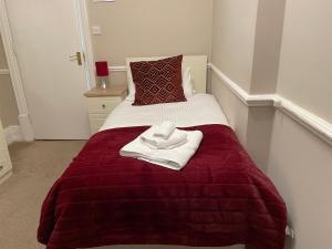 a bed with white towels sitting on top of it at The Sandrock in Clacton-on-Sea