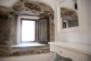 a bathroom with a window and a bath tub at Lida Mary in Mestá +28 photos
