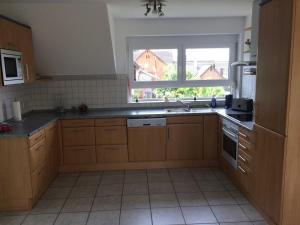 a kitchen with a sink and a window at Breig,s Ferienwohnung in Broggingen