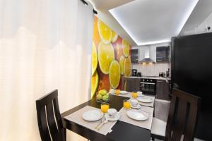 a kitchen with a table with plates and drinks on it at GR House Eleftheria in Afantou